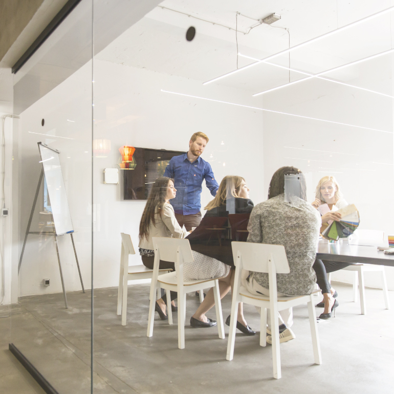 Group of work colleagues in a glass-fronted meeting room